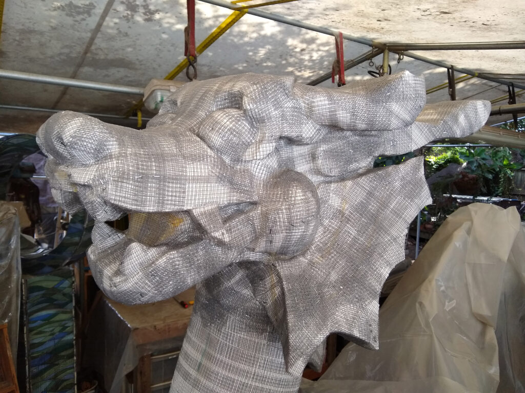 The first fiberglass tape layer as the dragon is created.