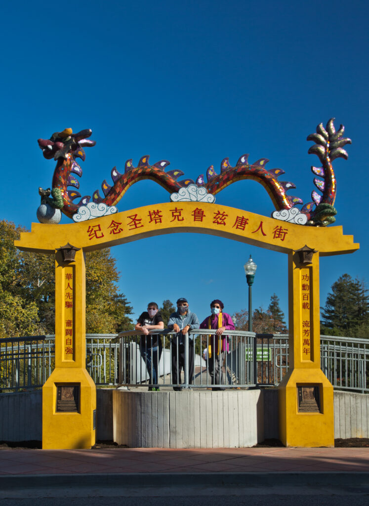 The completed Chinatown arch and dragon. (Kathleen, NAME and NAME, below L–R)